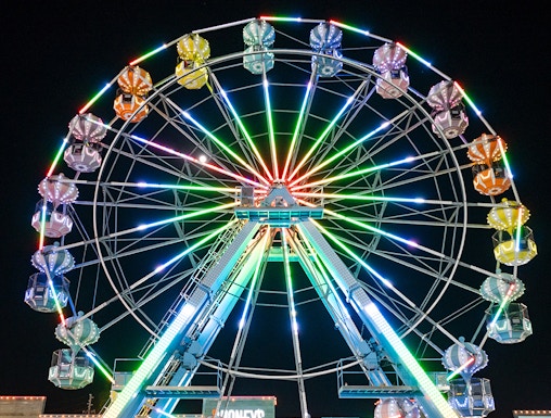 Old Town Ferris Wheel lit up at night in Orlando.