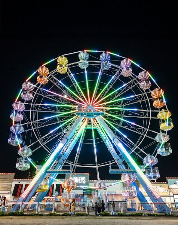 Old Town Ferris Wheel lit up at night in Orlando.