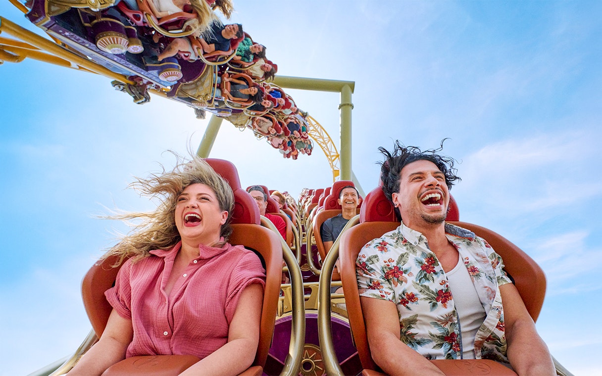 Thrill-seekers enjoying a rollercoaster ride at Epic Universe park, Universal Orlando, Florida.