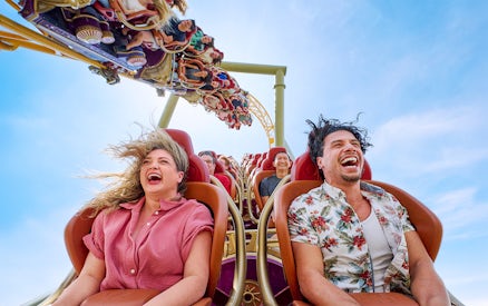 Thrill-seekers enjoying a rollercoaster ride at Epic Universe park, Universal Orlando, Florida.