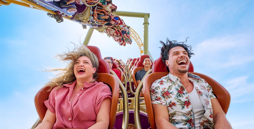 Thrill-seekers enjoying a rollercoaster ride at Epic Universe park, Universal Orlando, Florida.