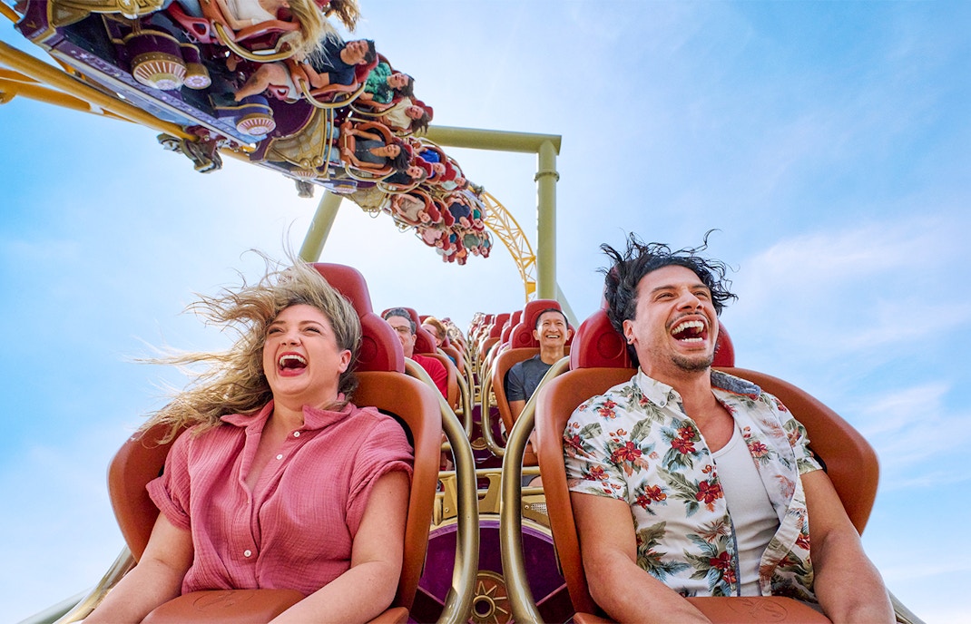 Thrill-seekers enjoying a rollercoaster ride at Epic Universe park, Universal Orlando, Florida.