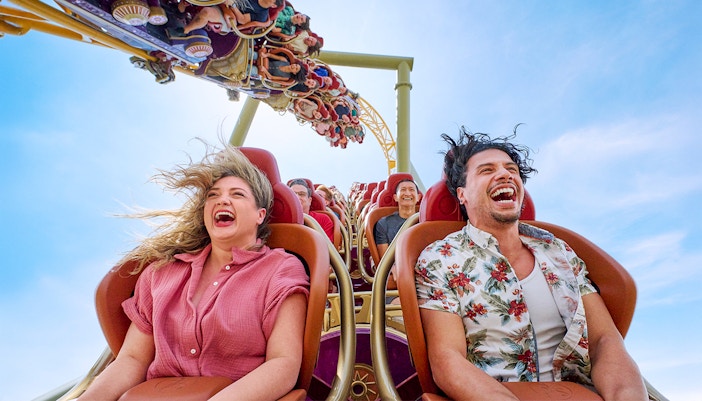 Thrill-seekers enjoying a rollercoaster ride at Epic Universe park, Universal Orlando, Florida.