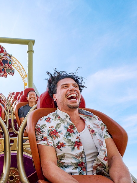 Thrill-seekers enjoying a rollercoaster ride at Epic Universe park, Universal Orlando, Florida.