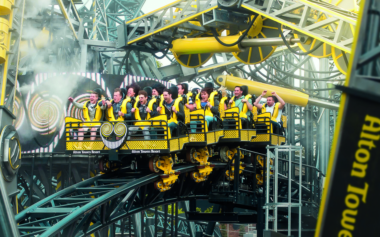 Riders on The Smiler roller coaster at Alton Towers, UK, experiencing a thrilling loop.