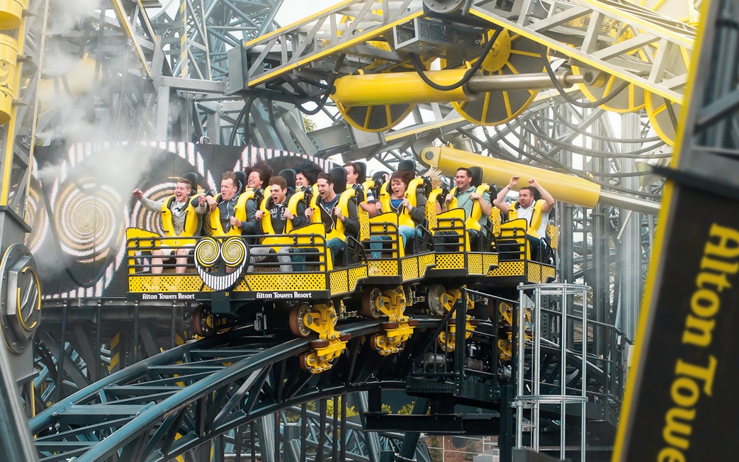 Riders on The Smiler roller coaster at Alton Towers, UK, experiencing a thrilling loop.