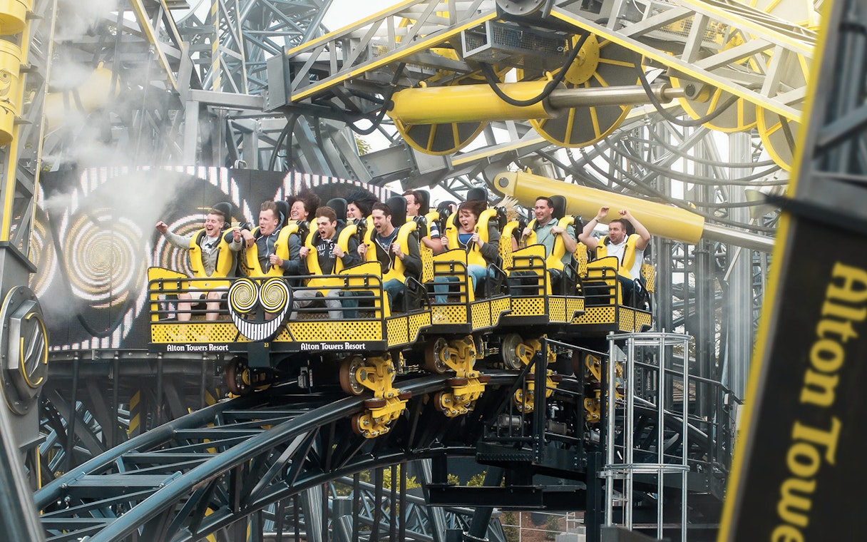 Riders on The Smiler roller coaster at Alton Towers, UK, experiencing a thrilling loop.