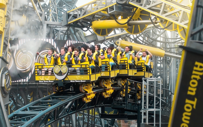 Riders on The Smiler roller coaster at Alton Towers, UK, experiencing a thrilling loop.