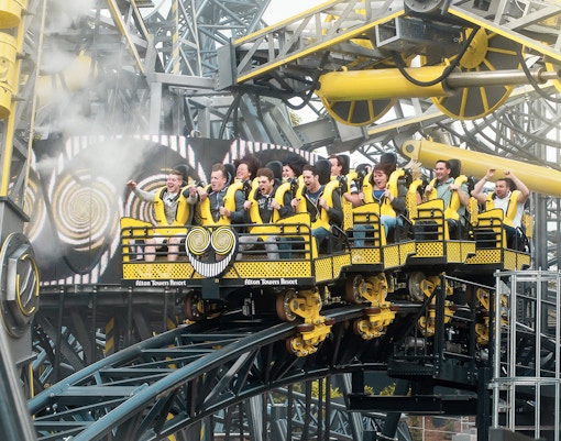 Riders on The Smiler roller coaster at Alton Towers, UK, experiencing a thrilling loop.
