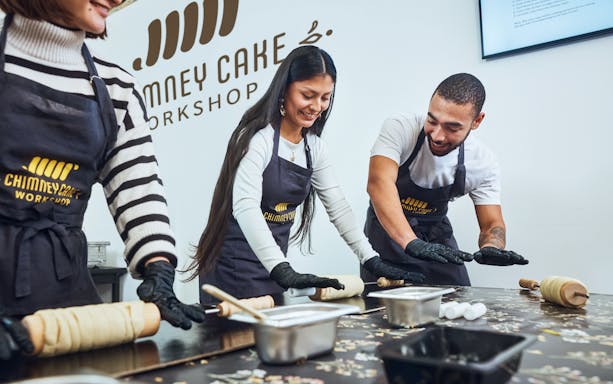Participants rolling dough at a Chimney Cake Workshop in Budapest.