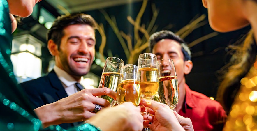 Cheerful group toasting champagne glasses at a celebration event.