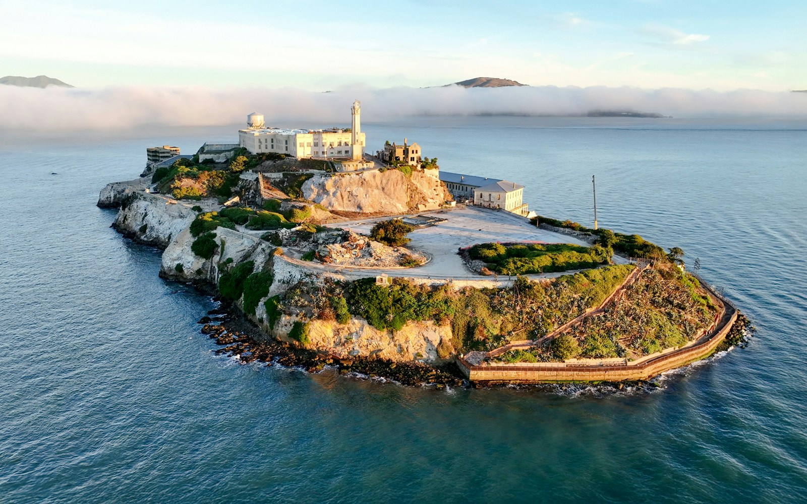 Alcatraz Island with ferry in San Francisco Bay, part of guided tour experience.