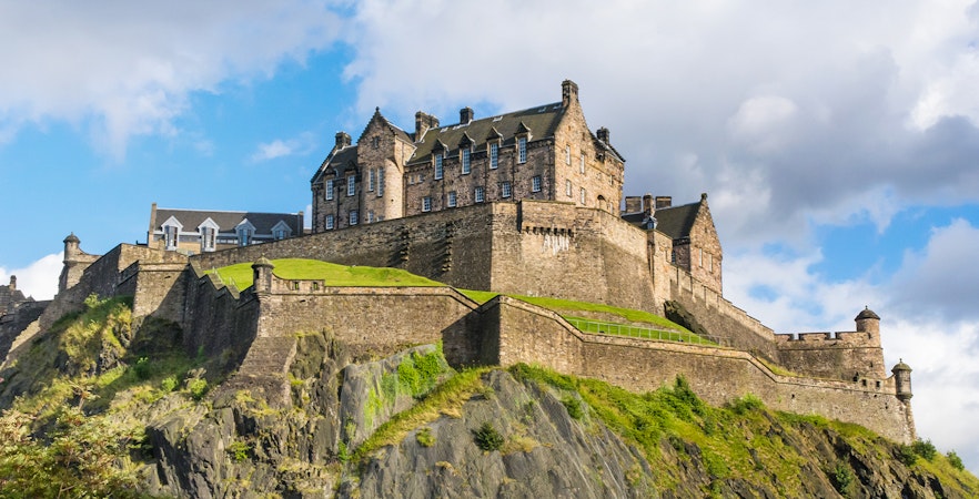 Edinburgh Castle on Castle Rock under a blue sky.