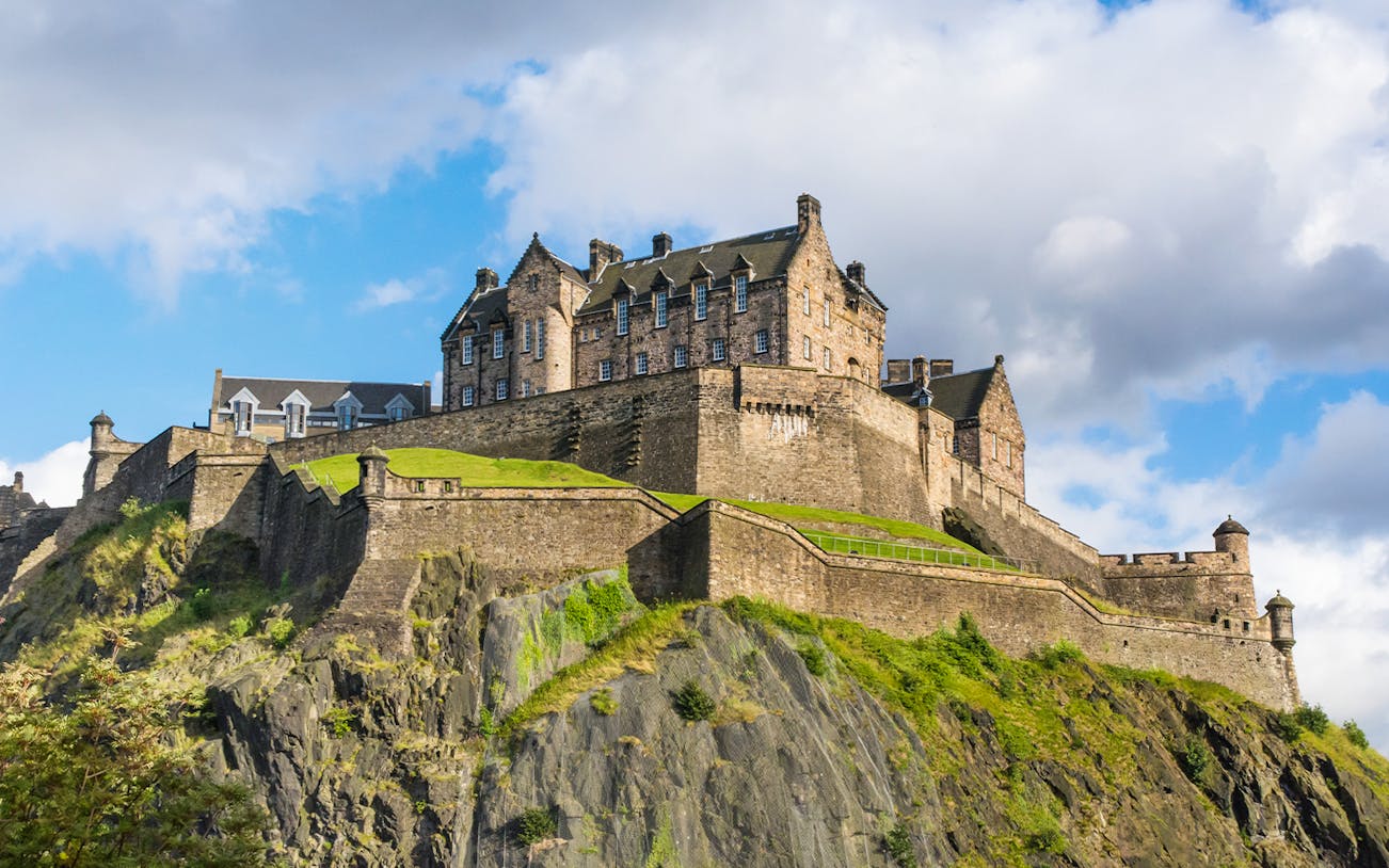 Edinburgh Castle on Castle Rock under a blue sky.