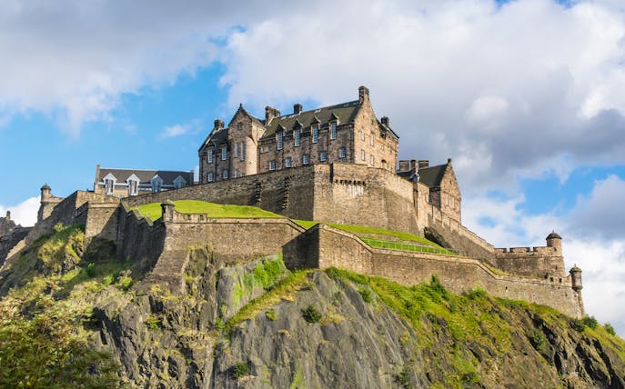 Edinburgh Castle on Castle Rock under a blue sky.