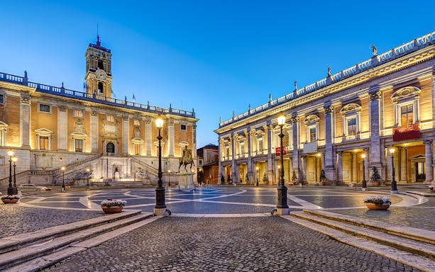 Capitoline Museums courtyard in Rome at dusk, featuring historic architecture and statues.