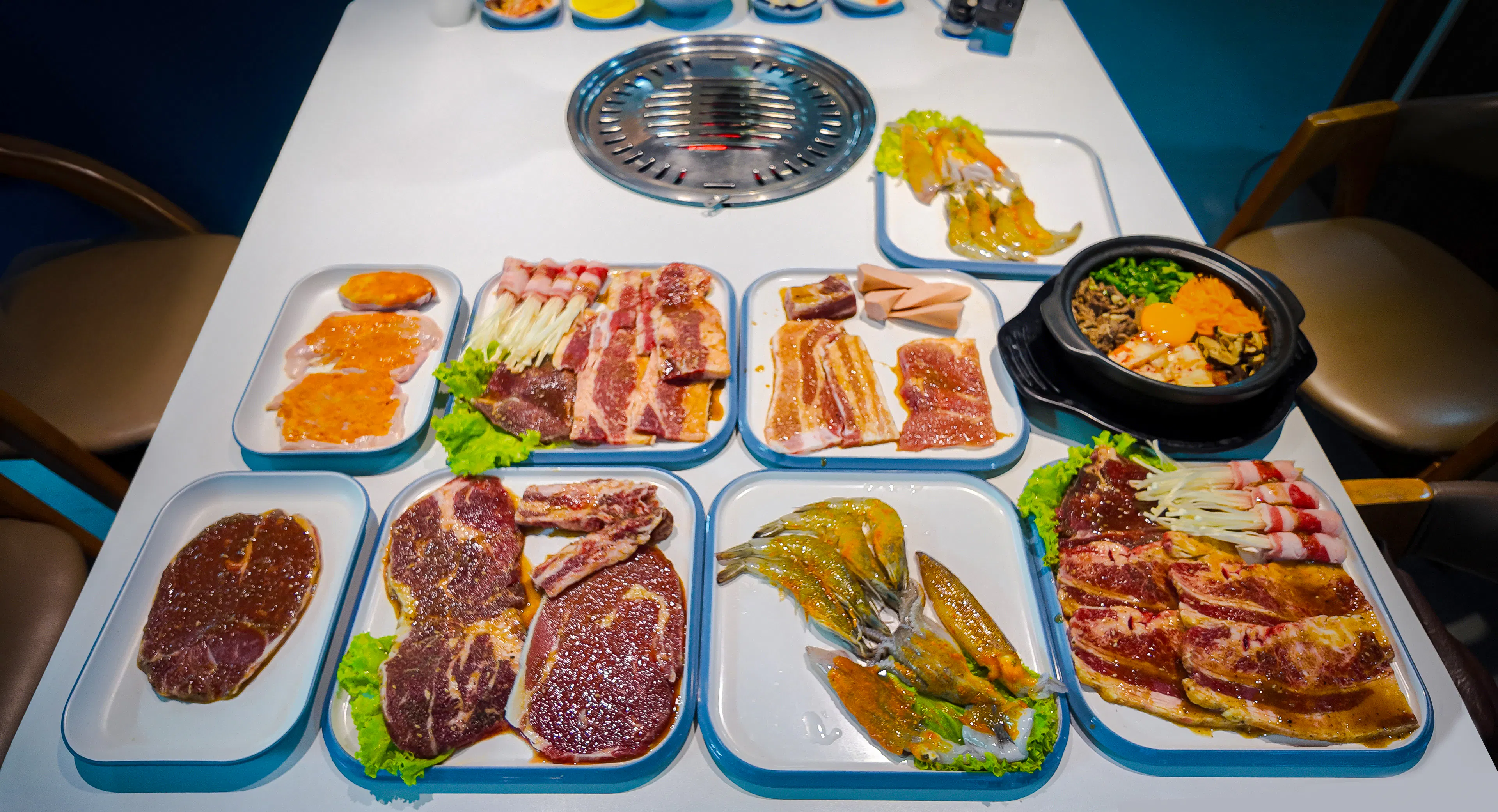 BBQ dinner spread with marinated meats and seafood on the Phu Quoc Sunset Tour.