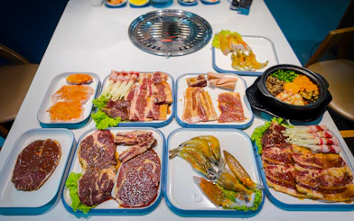 BBQ dinner spread with marinated meats and seafood on the Phu Quoc Sunset Tour.