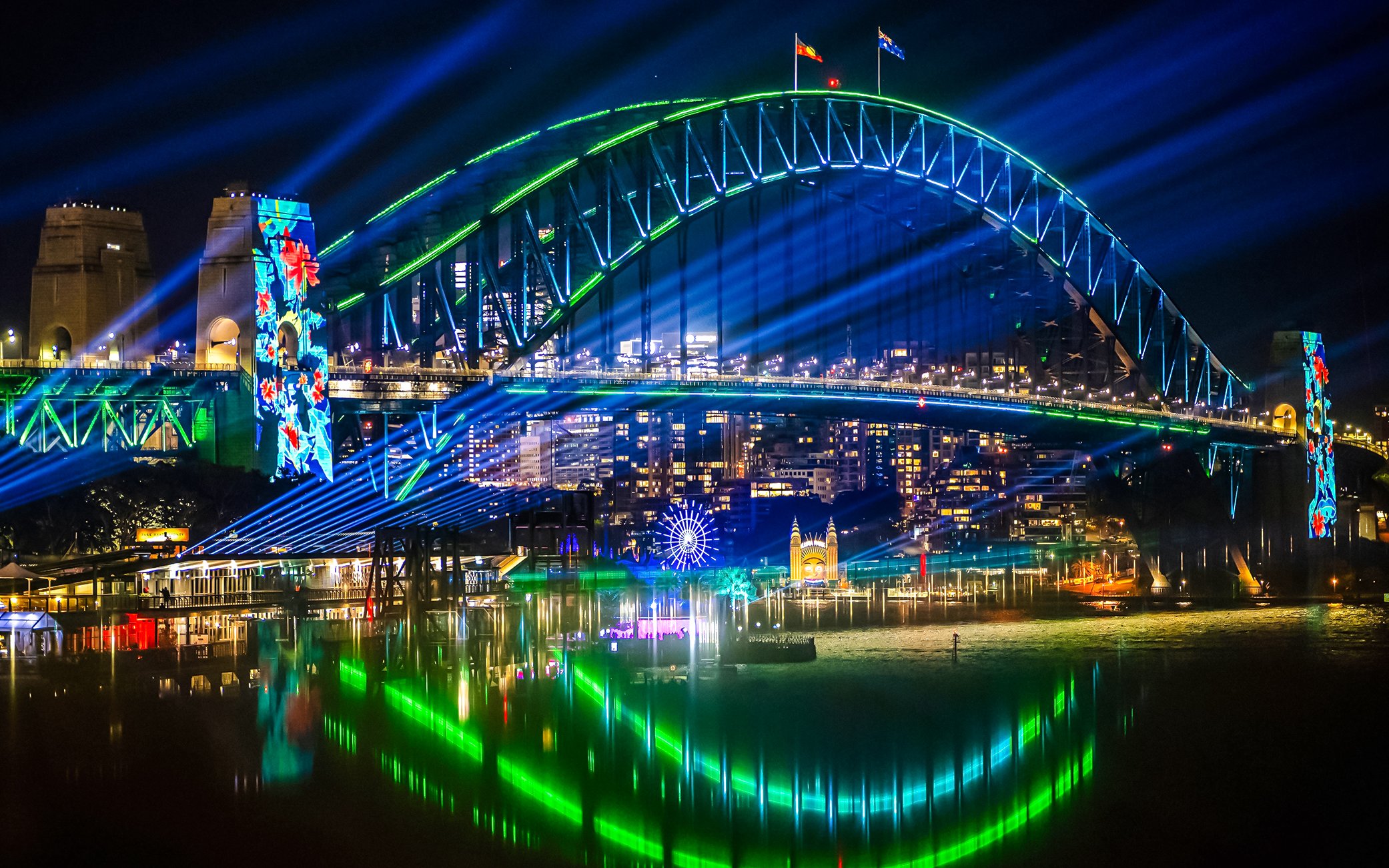 Sydney Harbour Bridge illuminated during Vivid Sydney cruise.