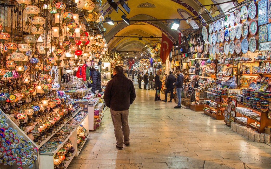 Grand Bazaar in Istanbul with colorful lamps and ceramics on display.