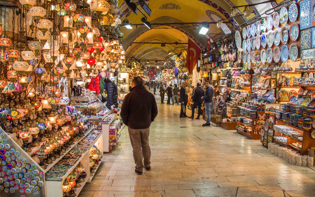 Grand Bazaar in Istanbul with colorful lamps and ceramics on display.