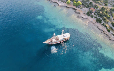 Boat party at Blue Lagoon, Split, Croatia with people swimming nearby.