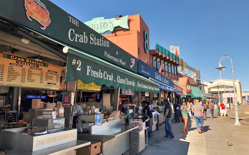 Crab stalls at Fisherman's Wharf, San Francisco Waterfront, with people browsing.