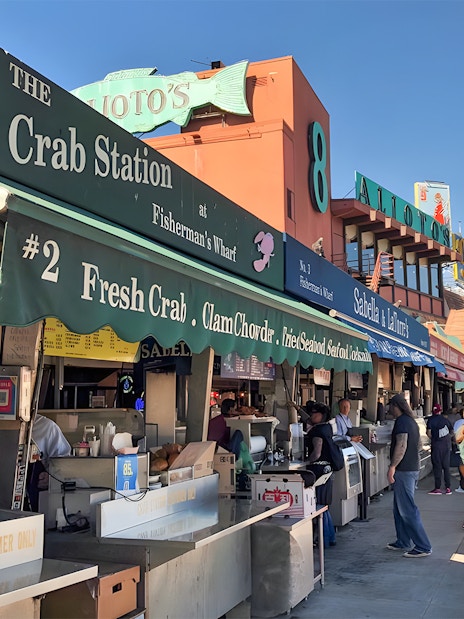 Crab stalls at Fisherman's Wharf, San Francisco Waterfront, with people browsing.