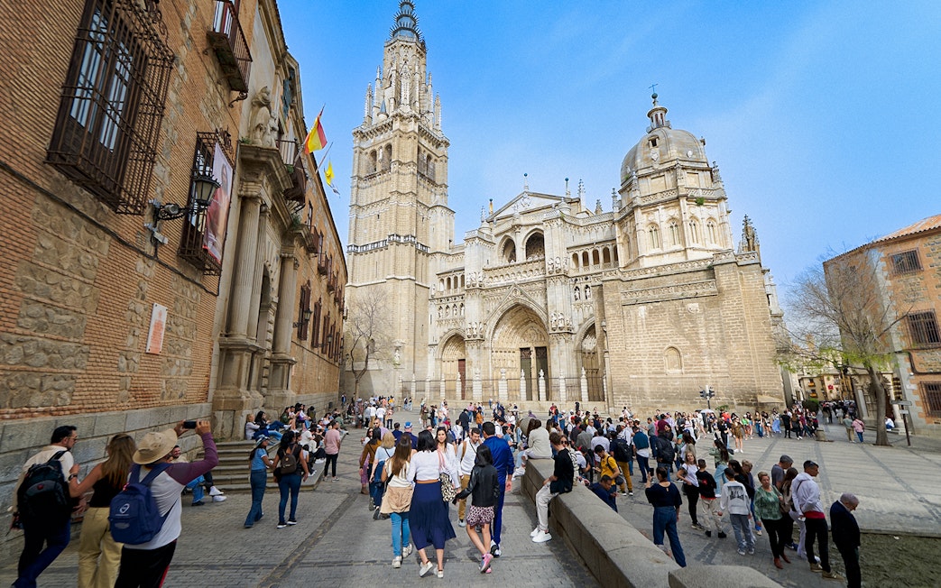 Visitors exploring Toledo Cathedral with a guide in Spain.