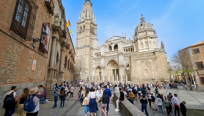 Visitors with a guide at Toledo Cathedral, Spain, exploring historic architecture.