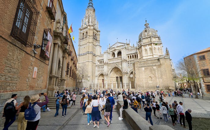 Visitors exploring Toledo Cathedral with a guide in Spain.