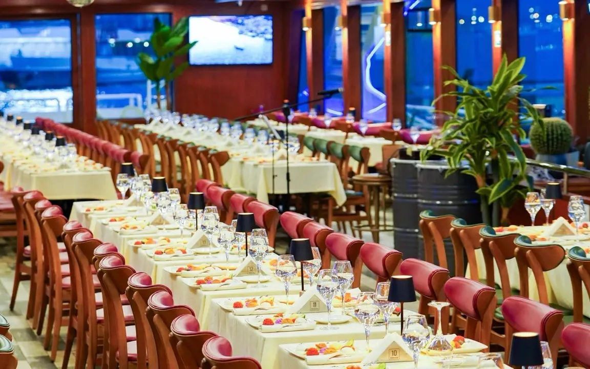Indoor dining setup on a Bosphorus dinner cruise boat in Istanbul, Turkey.