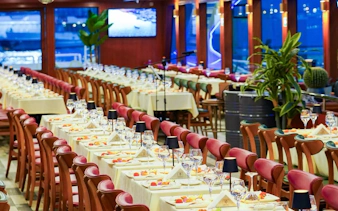 Indoor dining setup on a Bosphorus dinner cruise boat in Istanbul, Turkey.