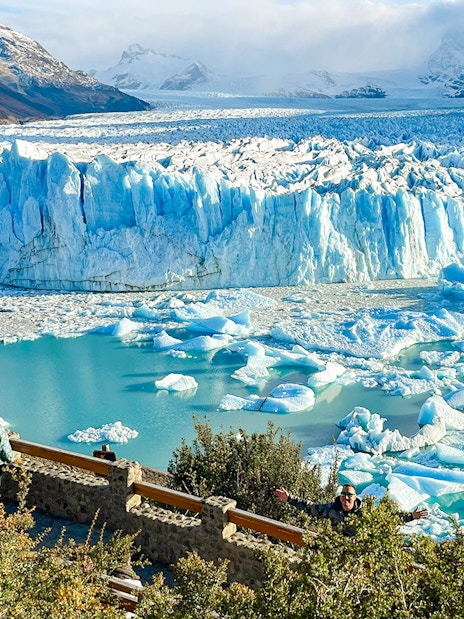 Visitors viewing the Perito Moreno Glacier in Argentina with icebergs floating in the turquoise water.