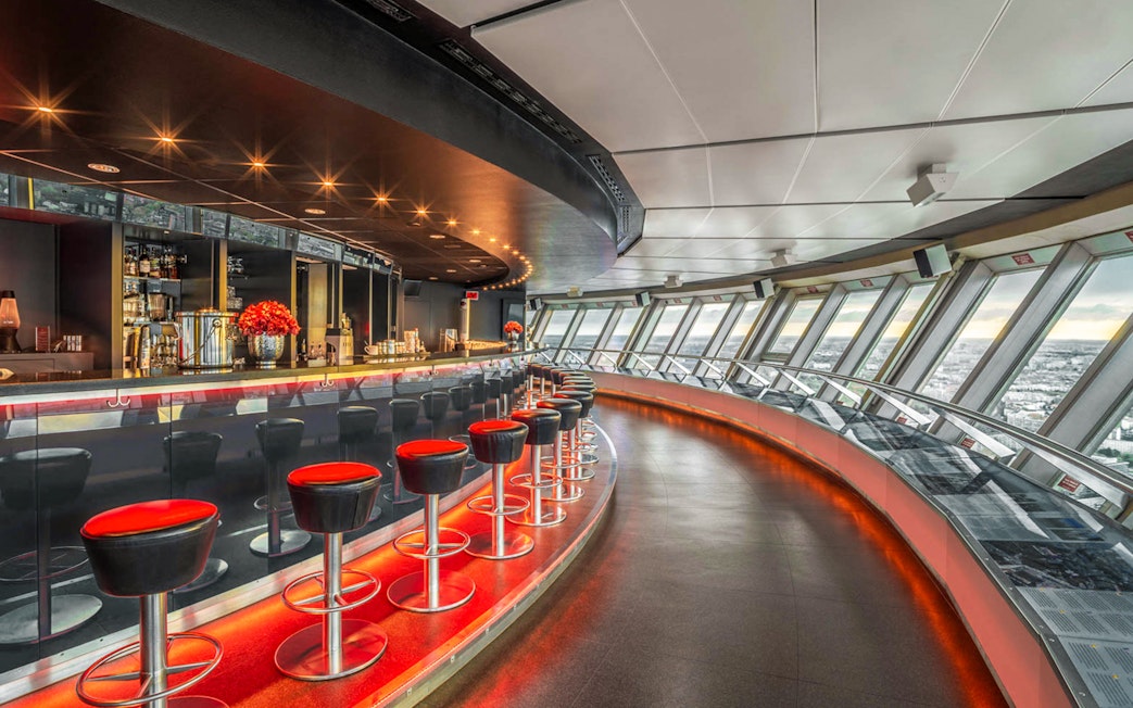 Dining area inside Berlin TV Tower with panoramic city views.