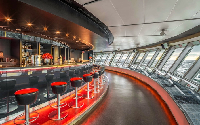Dining area inside Berlin TV Tower with panoramic city views.