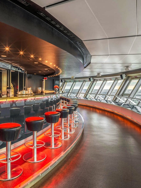 Dining area inside Berlin TV Tower with panoramic city views.