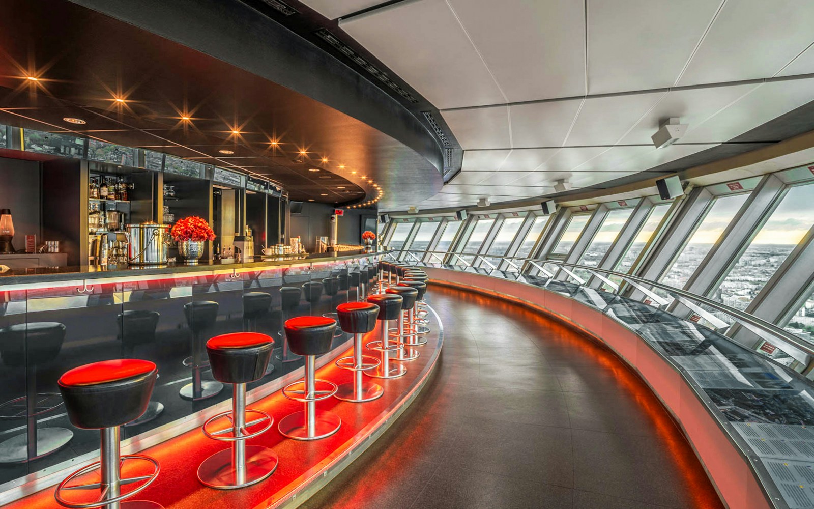 Dining area inside Berlin TV Tower with panoramic city views.