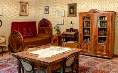 Franz Liszt House Museum interior with period furniture and sheet music in Budapest.