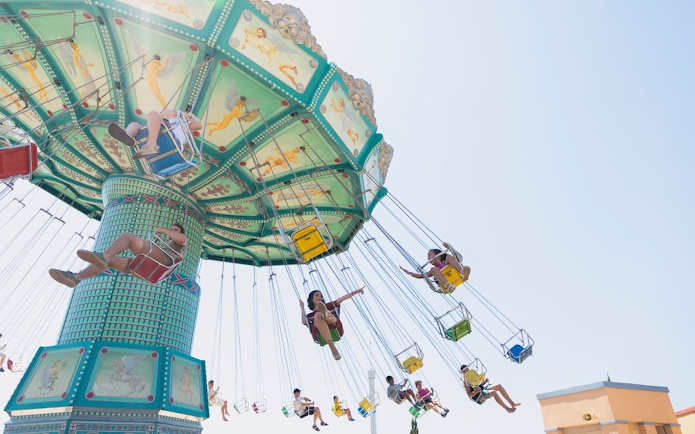 Swing ride at Terra Mitica Benidorm with people enjoying the attraction.