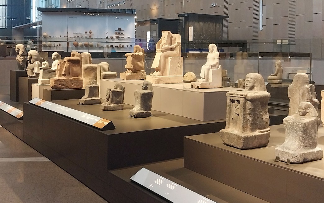 Ancient Egyptian statues displayed at the Grand Egyptian Museum.