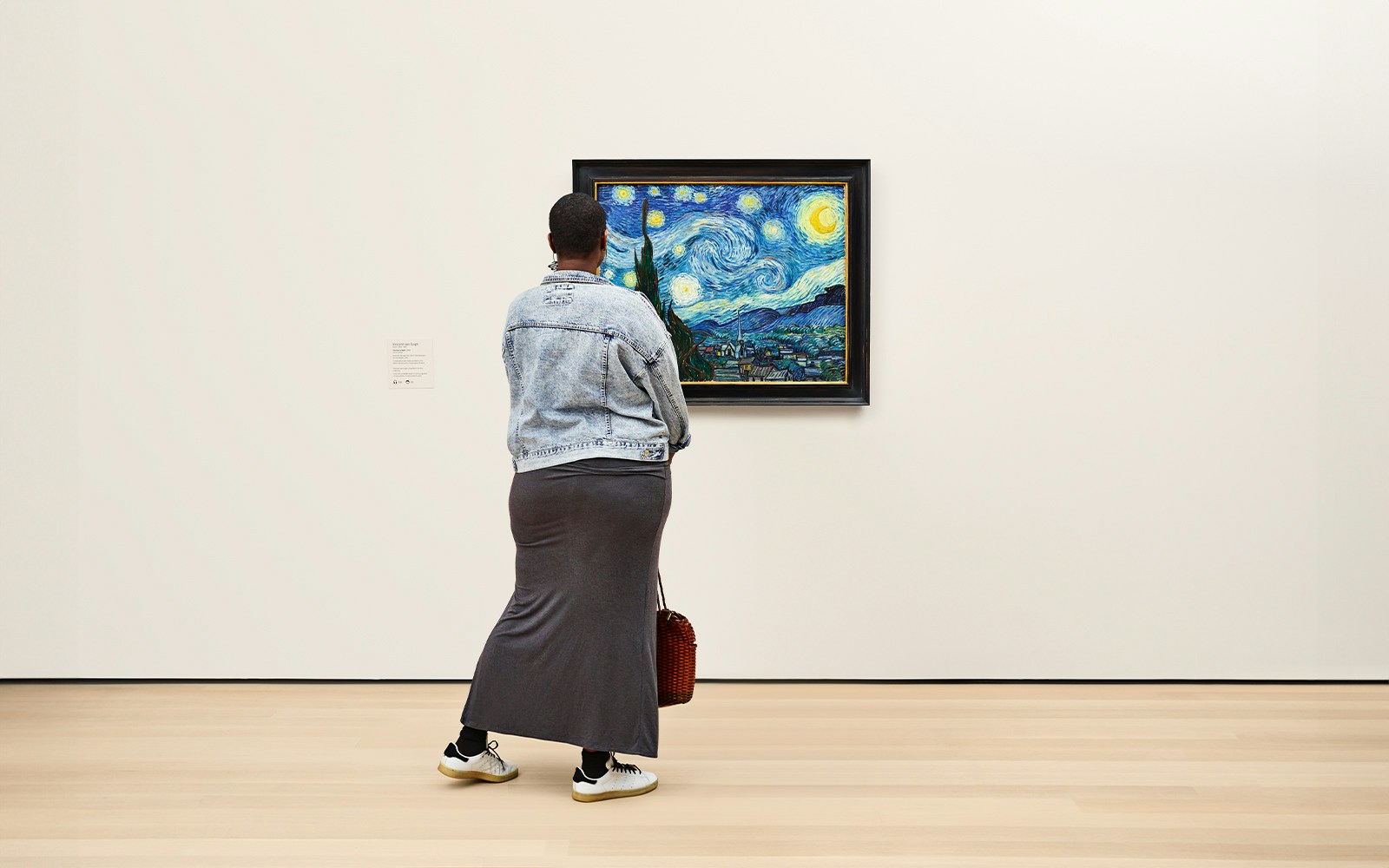Visitor viewing Van Gogh's 'Starry Night' at MoMA, New York City.