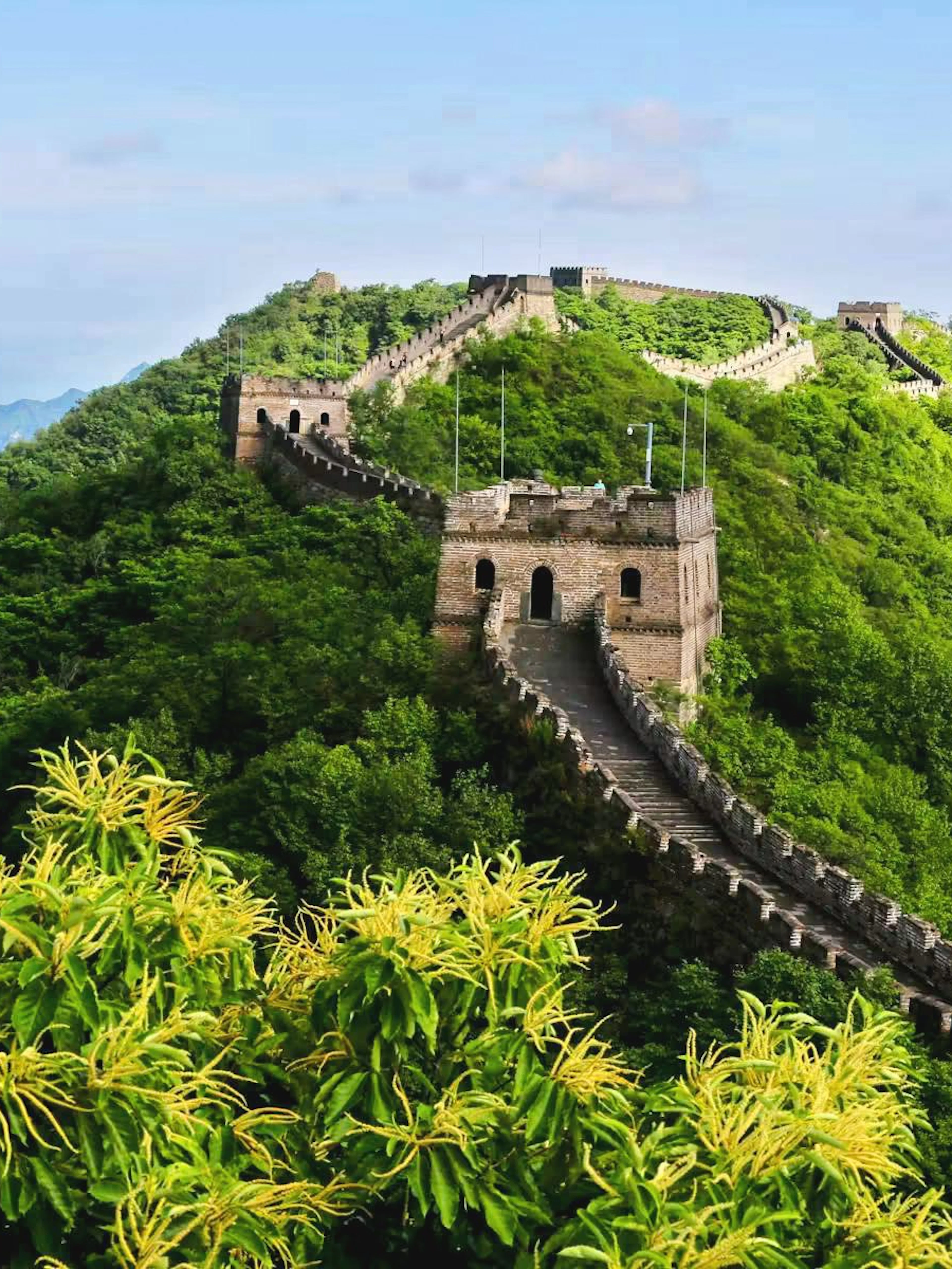 Mutianyu Great Wall winding through lush green hills in Huairou District, Beijing.