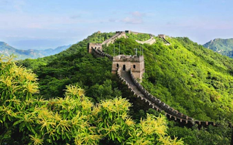 Mutianyu Great Wall winding through lush green hills in Huairou District, Beijing.