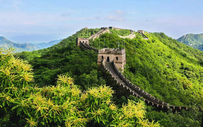 Mutianyu Great Wall winding through lush green hills in Huairou District, Beijing.
