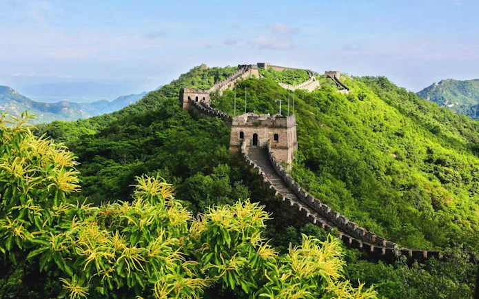 Mutianyu Great Wall winding through lush green hills in Huairou District, Beijing.