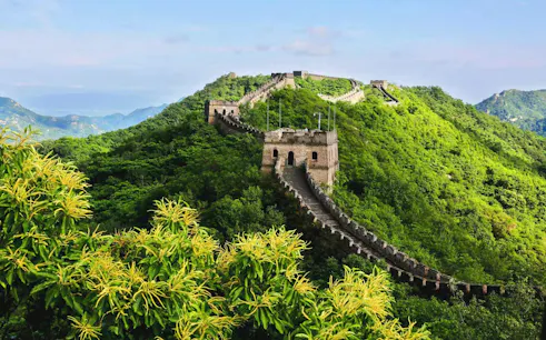 Mutianyu Great Wall winding through lush green hills in Huairou District, Beijing.