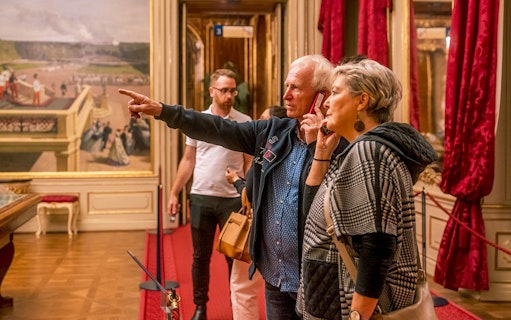Visitors exploring an ornate room during the Schonbrunn Palace tour.