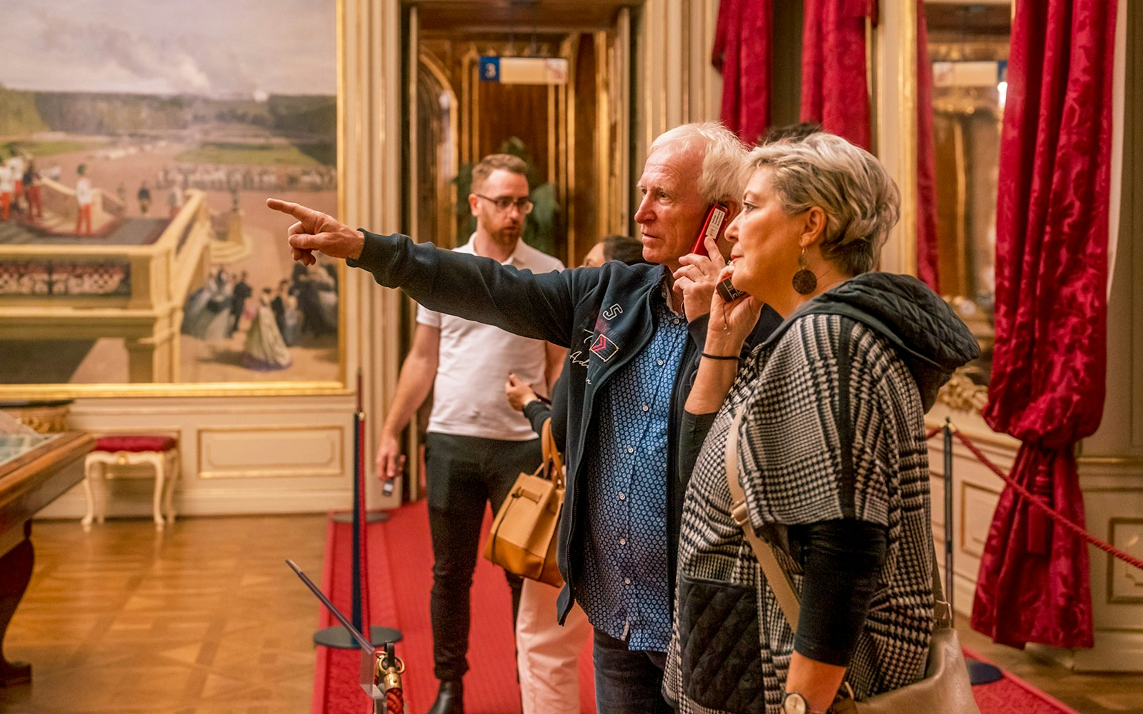 Visitors exploring an ornate room during the Schonbrunn Palace tour.