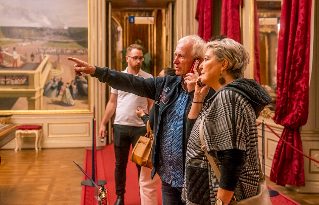 Visitors exploring an ornate room during the Schonbrunn Palace tour.